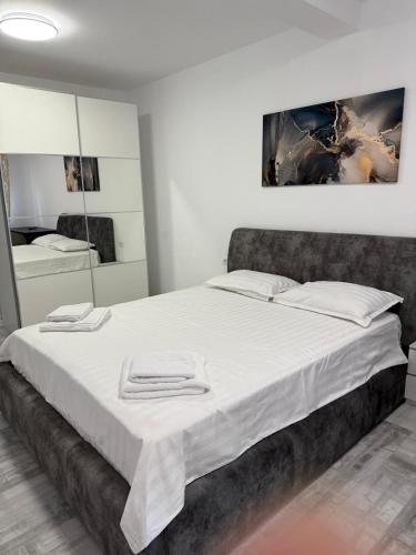 a bedroom with a large bed with white sheets at La Lumina in Lumina