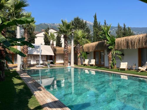 a swimming pool in front of a villa at BK Hotel in Fethiye