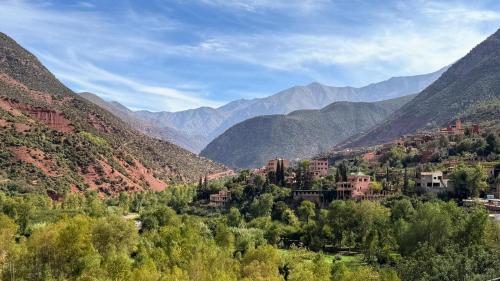 a town in a valley with mountains in the background at villa lalla Ourika & heated pool in Oulad Akkou