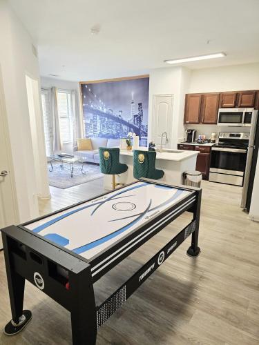 a room with a ping pong table in a kitchen at Frisco Vibes With Pool Gym and Elegant 1BR Apart in Frisco