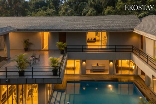 a house with a swimming pool in front of it at EKOSTAY Gold - AshBee Villa in Kīhīm