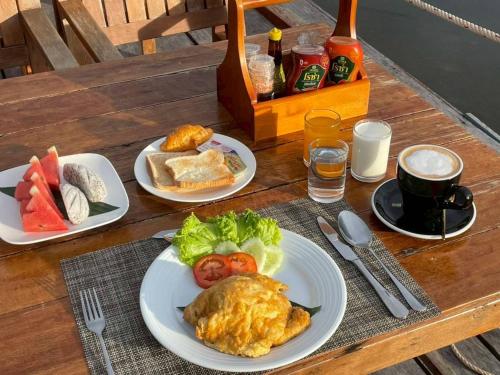 a table with three plates of food on it at Moana Resort Koh Kood in Ban Lak Uan