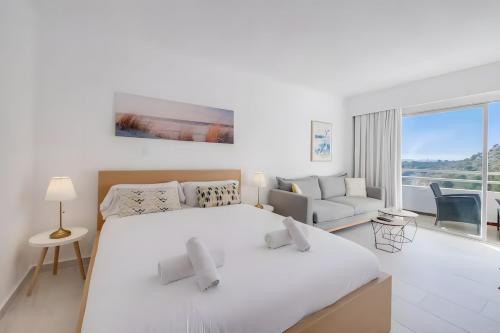 En eller flere senge i et værelse på Siesta Style