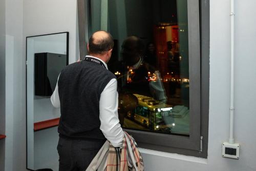 a man looking out of a window at a man at Hotello Padova in Padova