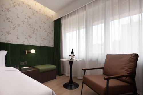 a bedroom with a bed and a chair and a window at Fengqi Wutong Holiday Hotel - Changsha Wuyi Avenue Railway Station Metro Station Branch in Changsha