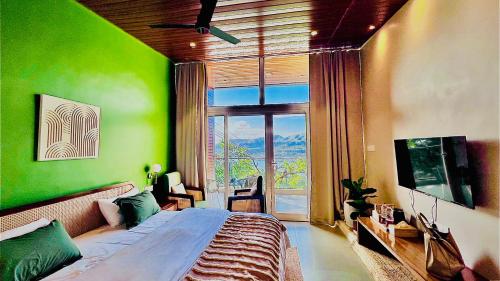 a bedroom with a large bed and a large window at The Chalets, Mulshi in Wadgaon