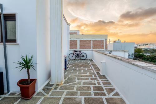 a balcony with a bike sitting on a building at L'aurora in San Vito dei Normanni