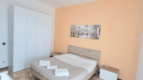 a bedroom with a bed with a picture on the wall at Sunrise in Bergamo