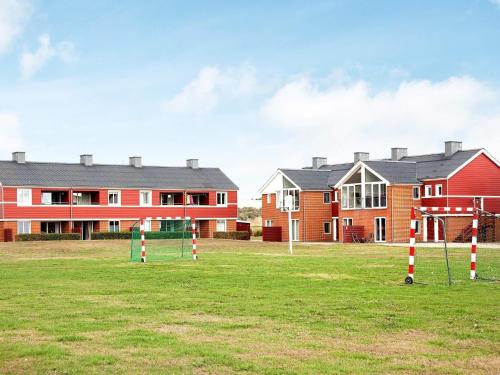 a group of houses in a field with a playground at 5 person holiday home on a holiday park in Lemvig in Lemvig