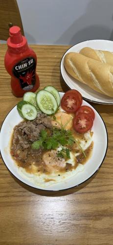 two plates of food on a table with a plate of food at Madam Thu House in Hue