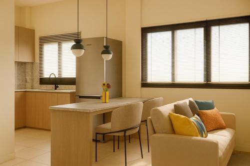 a kitchen and living room with a couch and a table at Ban Chang Pet-Friendly Hotel in Ban Chang