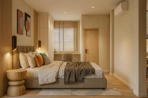 a bedroom with a large bed and a window at Ban Chang Pet-Friendly Hotel in Ban Chang