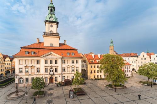 a large building with a clock tower on top of it at Ratuszove Love - dwie osobne sypialnie, w rynku - by Everslow in Jelenia Góra