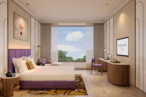 Postel nebo postele na pokoji v ubytování Vivanta Ekta Nagar