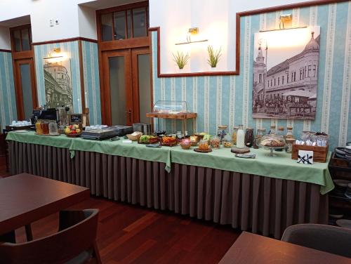 a table with food on it in a restaurant at Hotel Golden Eagle in Levice
