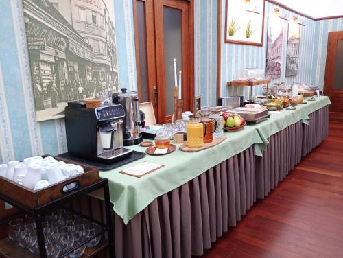 a long table with food on it in a room at Hotel Golden Eagle in Levice