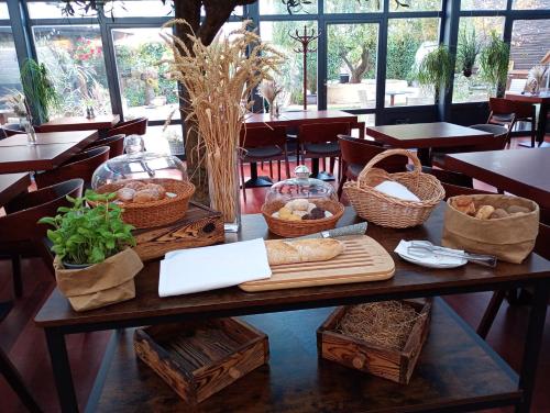 a table with baskets of bread and other items on it at Hotel Golden Eagle in Levice