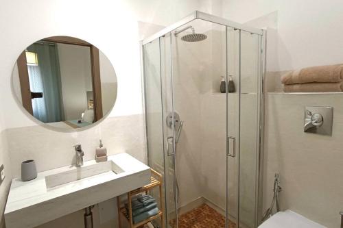 a bathroom with a shower and a sink and a mirror at Arcu de chelu - guest house in Modolo
