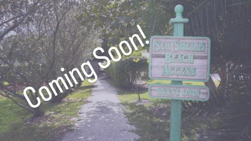 a sign for a golf course with a sign at Seashells #42 in Ybel