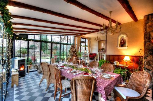 ein Esszimmer mit Tisch und Stühlen und einem Kamin in der Unterkunft La Ermita de los Llanos in Arenas de San Pedro