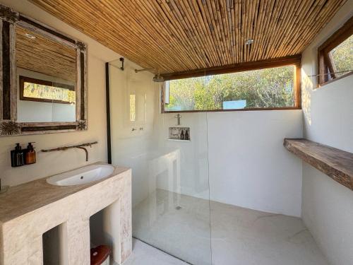 a bathroom with a sink and a glass shower at Thorn & Feather, Vermaaklikheid in Vermaaklikheid