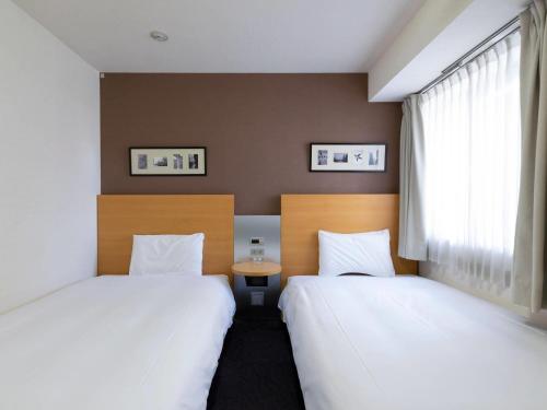 Postel nebo postele na pokoji v ubytování Comfort Hotel Osaka Shinsaibashi