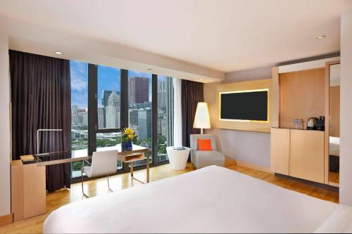 a bedroom with a bed and a desk with a monitor at Radisson Blu Aqua Hotel, Chicago in Chicago