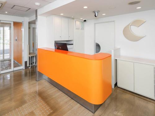 an office with an orange counter in an office at Comfort Inn Chiba Hamano in Chiba
