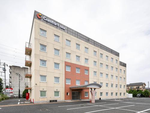 a building with a sign on the side of it at Comfort Inn Utsunomiya Kanuma in Utsunomiya