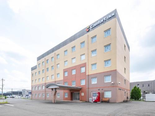 a building with a sign on the side of it at Comfort Inn Fukui in Fukui