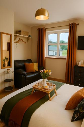 a bedroom with a bed and a table with flowers on it at The Acres Retreat -Cosy and Welcoming in Lisnaskea