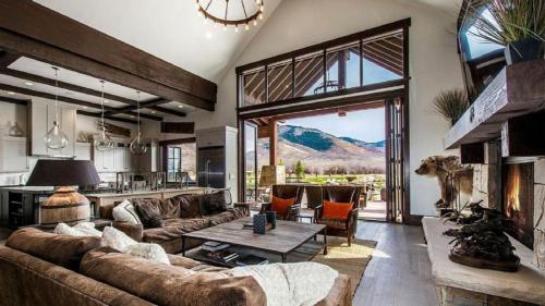 a living room with a couch and a table at Impressive and Secluded Villa for Rent along the Glorious Uinta Mountains, Utah in Oakley