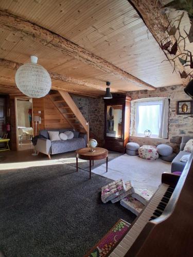a living room with a couch and a table at Amtawa - Bien-être et Ressourcement in Kirchberg
