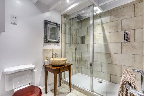 a bathroom with a shower and a sink at 4 Court Cottages in Blockley