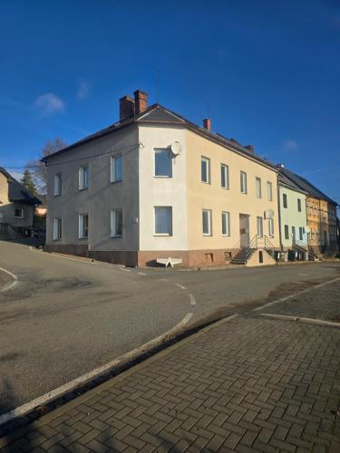 a large white building on the side of a street at Apartmán 28 in Horní Město