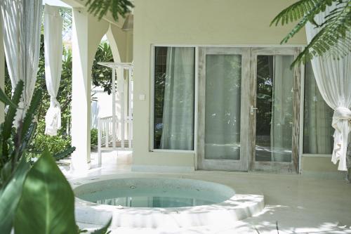 a room with a tub in the middle of a house at White Villa Paparemo Village in Watamu
