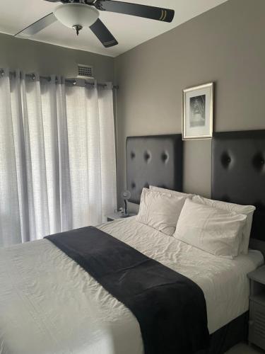 a bedroom with a bed and a ceiling fan at Beachfront apartment in Ballito! Casablanca in Ballito
