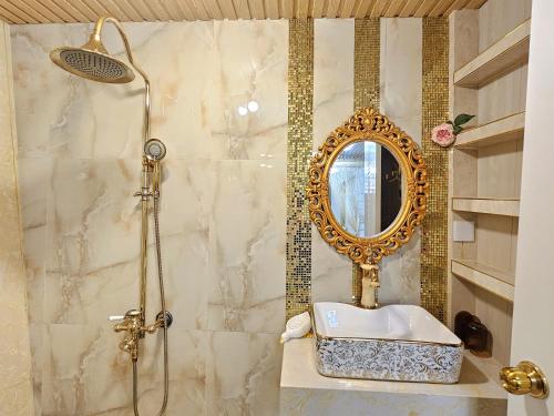 a bathroom with a shower with a sink and a mirror at Biệt Thự cao cấp Lâu Đài Nhỏ Đà Lạt - Little Castle Da Lat Villa in Da Thien