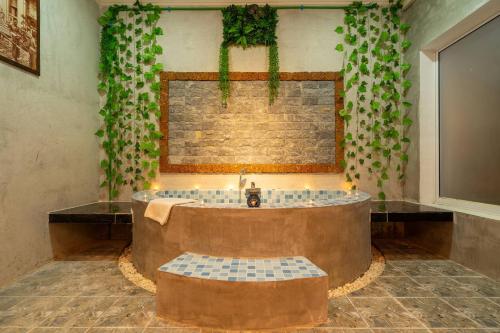 a bathroom with a large tub with a sink at Angkor Rithy Residence team in Siem Reap