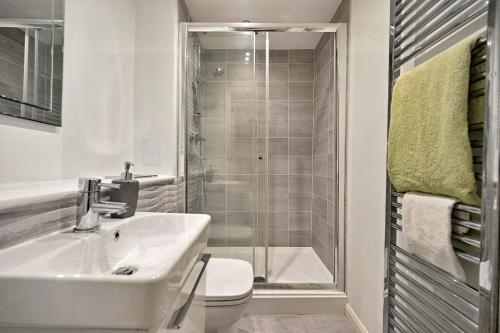 a bathroom with a sink and a toilet and a shower at Finest Retreats - Riverside View in Balloch