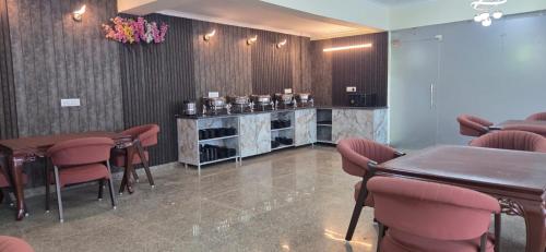 a waiting room with chairs and a table and a salon at Hotel Fortune Home Residency Sector 72 in Noida