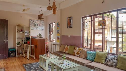 a living room with a couch and a table at Thikana by Mulaqat in Siliguri