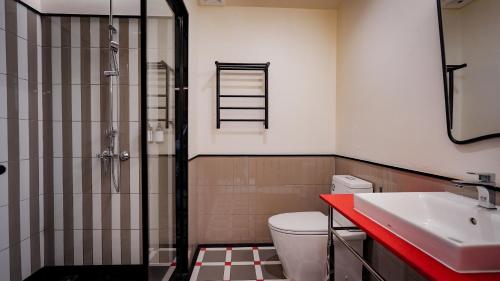 a bathroom with a shower and a toilet and a sink at Sugar Marina Hotel -POP- Kata Beach in Kata Beach