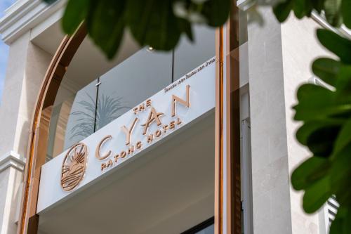 a sign for a cafe on the side of a building at The Cyan at Patong Hotel in Patong Beach