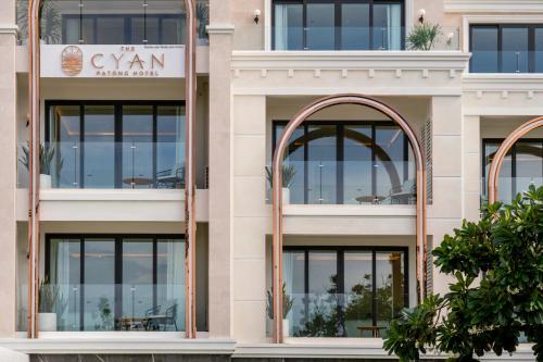 a facade of a building with large windows at The Cyan at Patong Hotel in Patong Beach