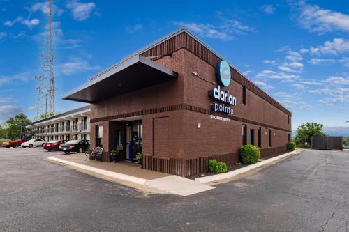 a brown brick building with a sign on it at Clarion Pointe Winston - Salem Downtown in Winston-Salem