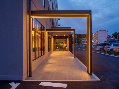 a hallway of a building with an open door at Comfort Hotel Kii Tanabe in Tanabe