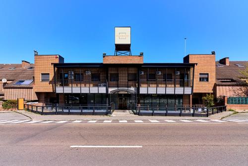 a large brick building with a sign on top of it at Hotel Villamayor by gaiarooms in Villamayor