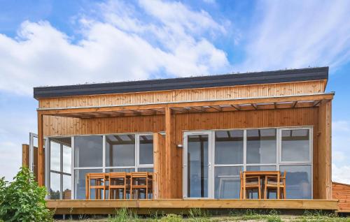 a wooden house with a lot of windows at 5 Bedroom Amazing Home In Hanstholm in Pugdal