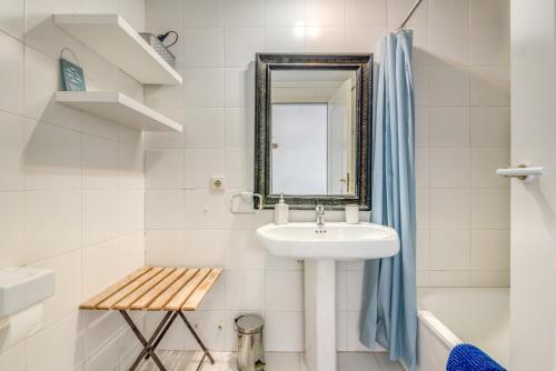a bathroom with a sink and a mirror at Jávea Beachfront Penthouse in Platja de l'Arenal